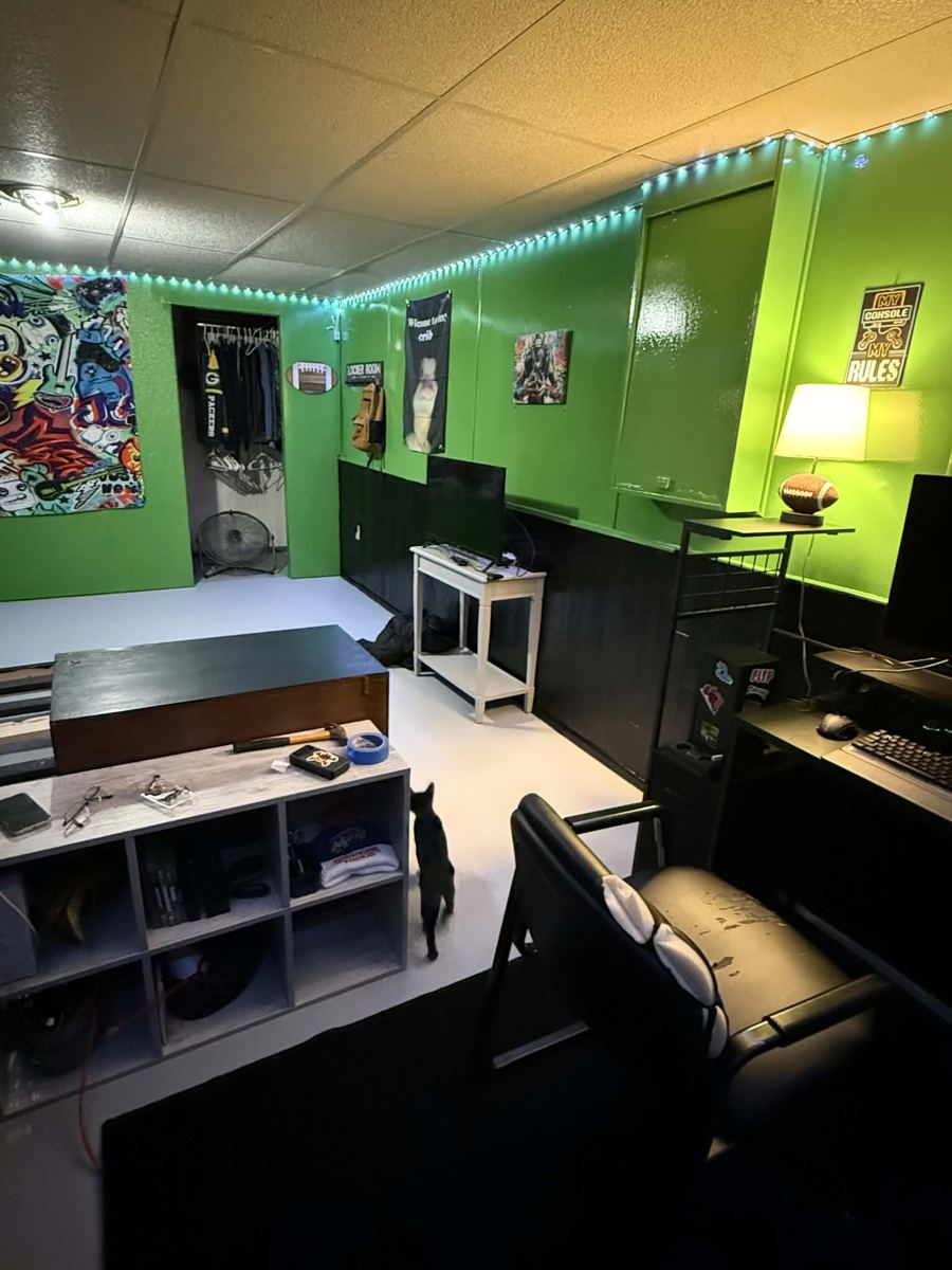 Finished basement room with green walls, LED lighting and a desk setup