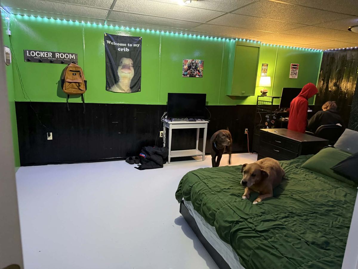 Finished basement game room with green walls and LED lighting