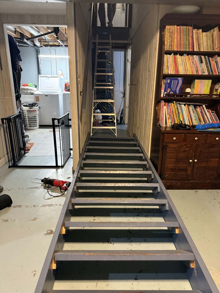 Rebuilt basement stairs with painted treads and lit risers