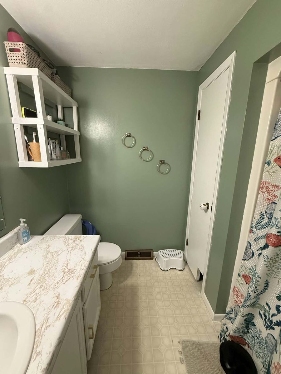 Finished sage bathroom looking toward the shower