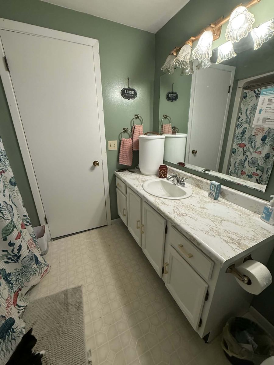 Refitted bathroom with sage walls and a new marble-look vanity top