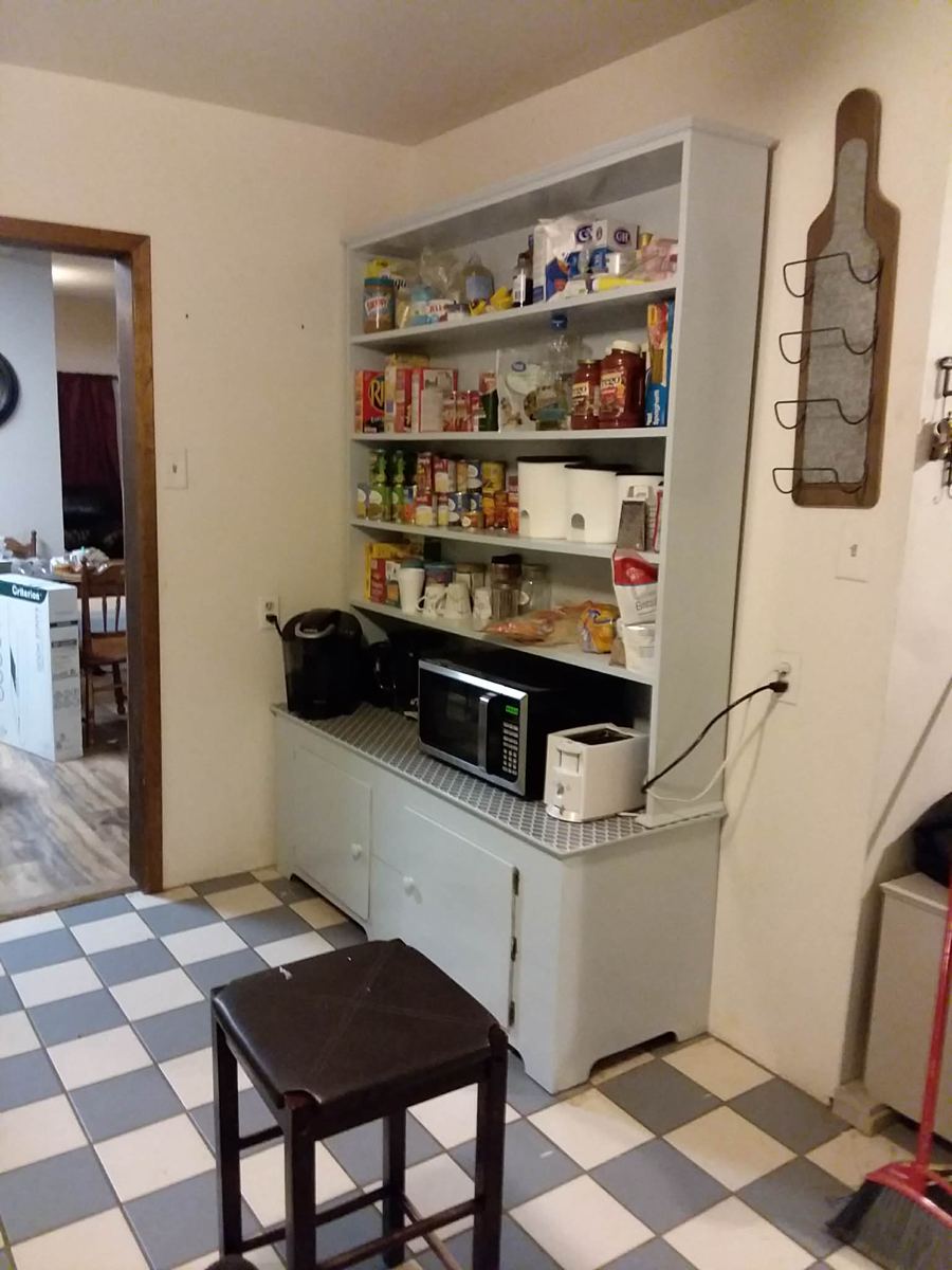 Custom built-in pantry hutch with open shelving, fully stocked