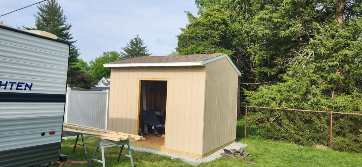 Newly built backyard shed with siding on